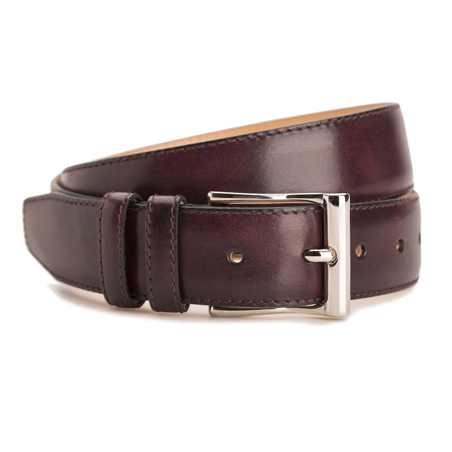 Meermin plum museum calf belt, coiled to show buckle detail with nickel-plated solid brass hardware and double keeper loops