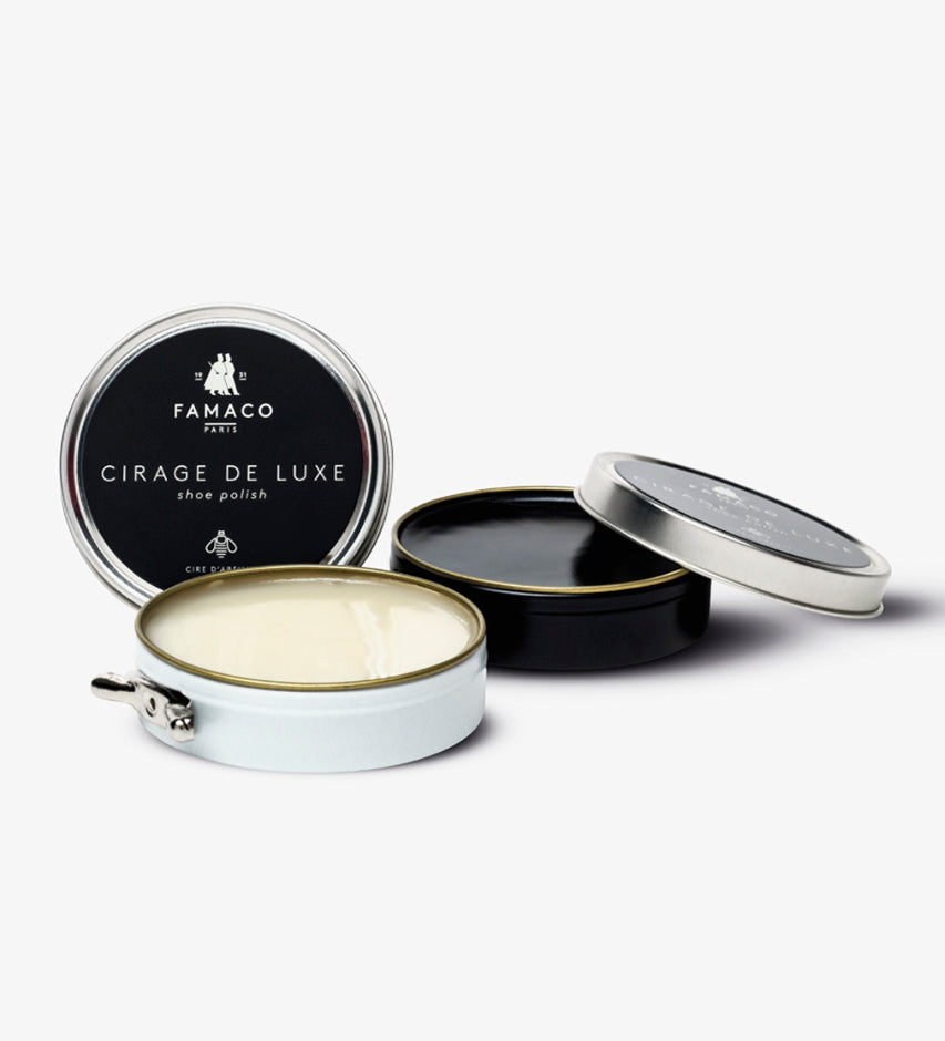 Three open Famaco Cirage de Luxe tins stacked, revealing cream-colored beeswax polish and black lids and cases
