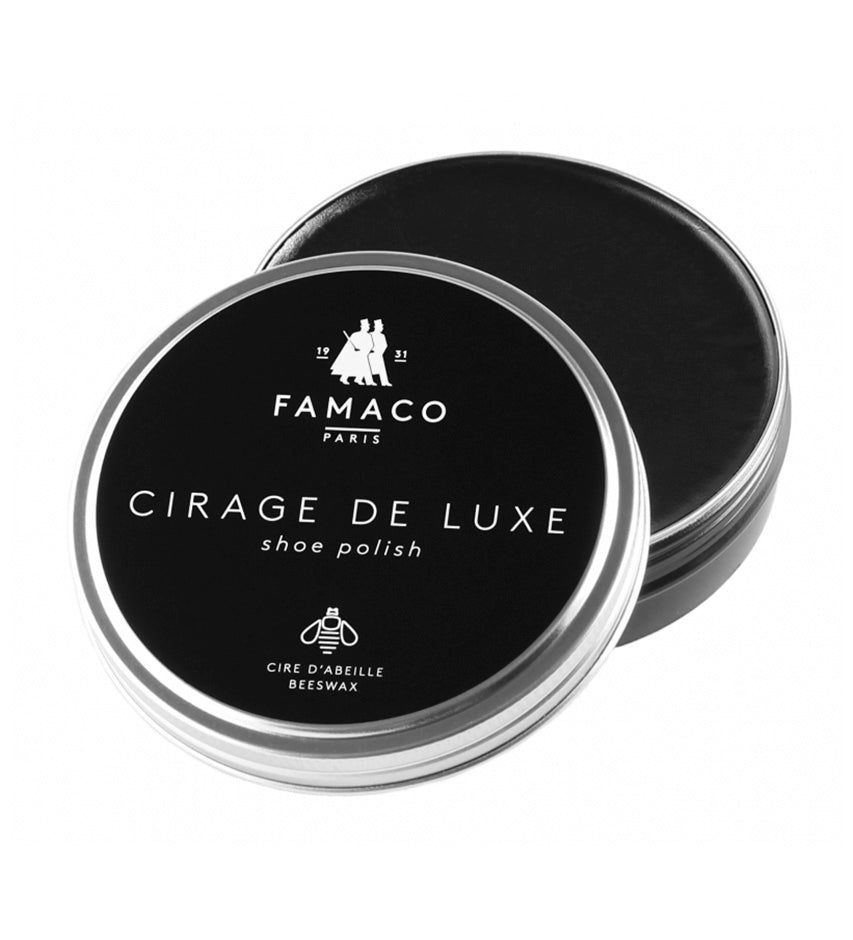 Famaco Cirage de Luxe black shoe polish tin, closed lid facing forward with open lid behind revealing black wax fill