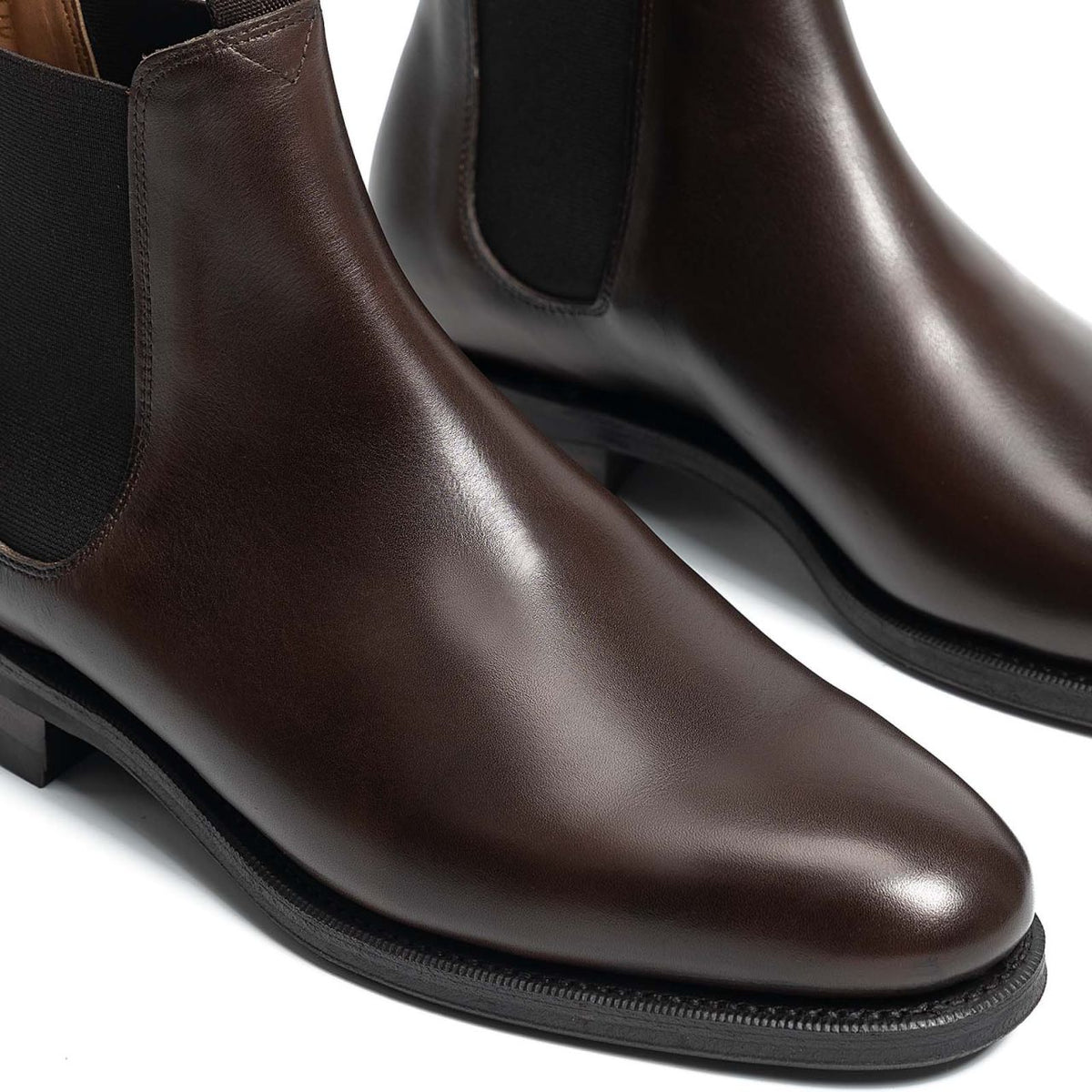 Meermin dark brown calf Chelsea boots, close-up toe and side elastic detail showing smooth leather grain and Goodyear welted sole