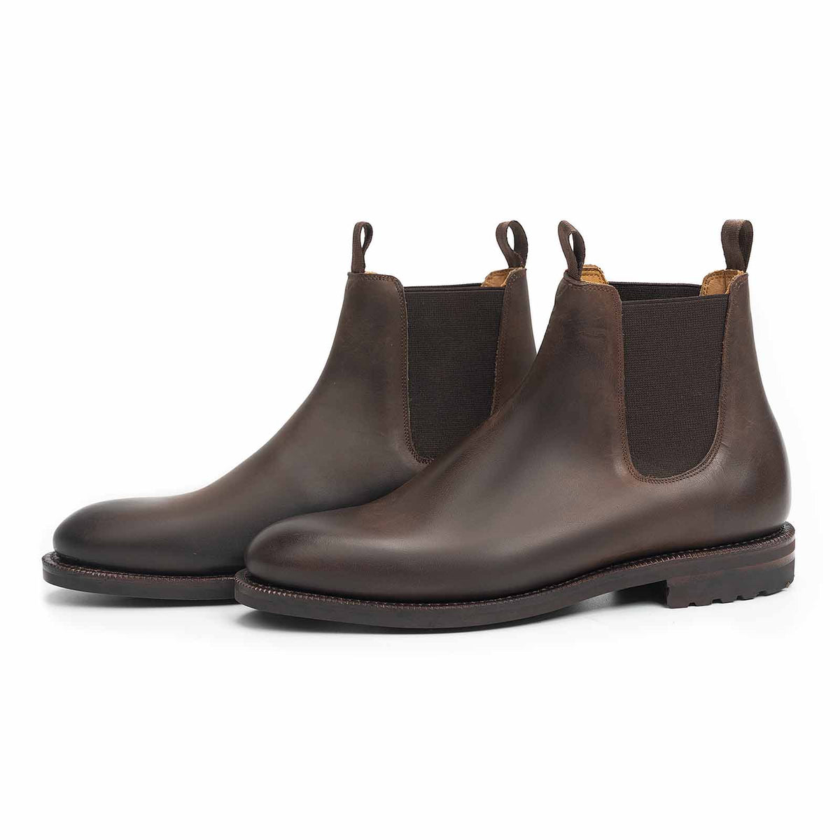 Meermin brown waxy calf wholecut Chelsea boots, three-quarter front view showing elastic side gussets and lug outsole