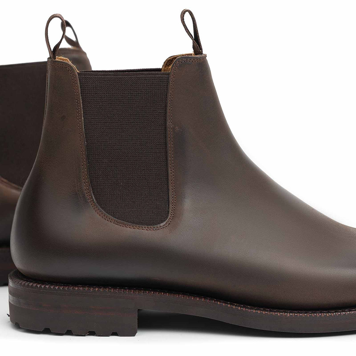 Meermin brown waxy calf Chelsea boots, close-up on heel pull tabs and elastic gusset, showing lug outsole detail