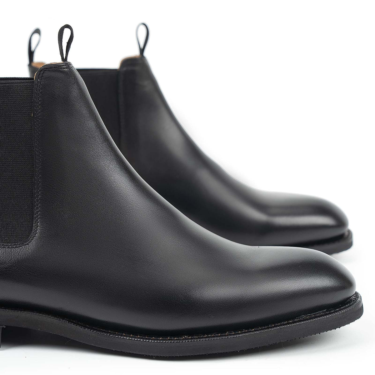Meermin black silkcalf Chelsea boots, close-up front view showing elastic side panels, pull tabs, and smooth wholecut toe