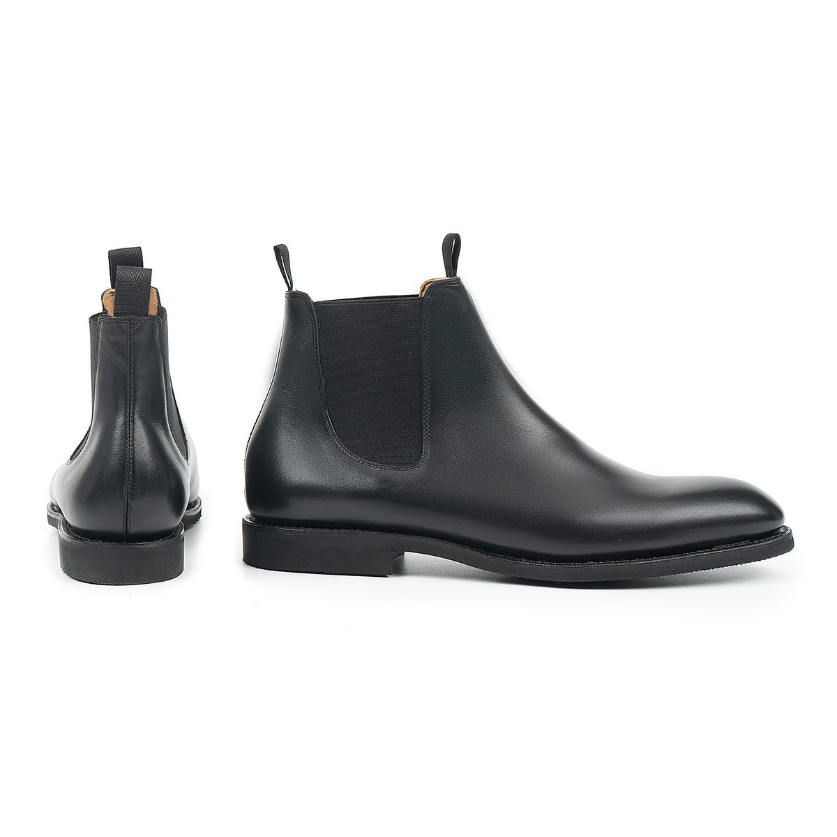 Meermin black silkcalf Chelsea boots, side and back views showing elastic gores, pull tabs, and diamond latex rubber sole profile