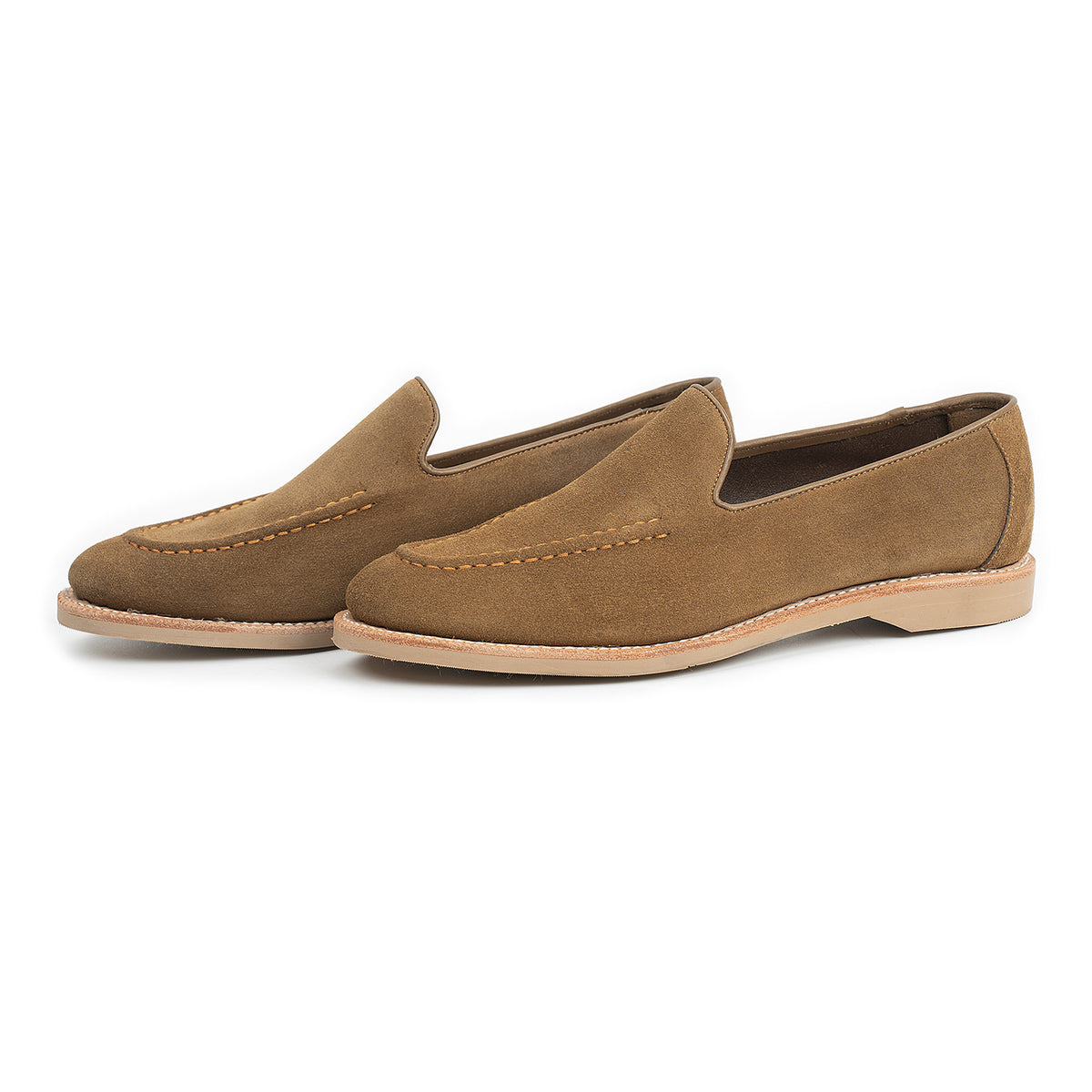 Meermin Atacama suede unlined loafers, three-quarter side view showing hand-sewn apron stitching and tonal taupe rubber sole