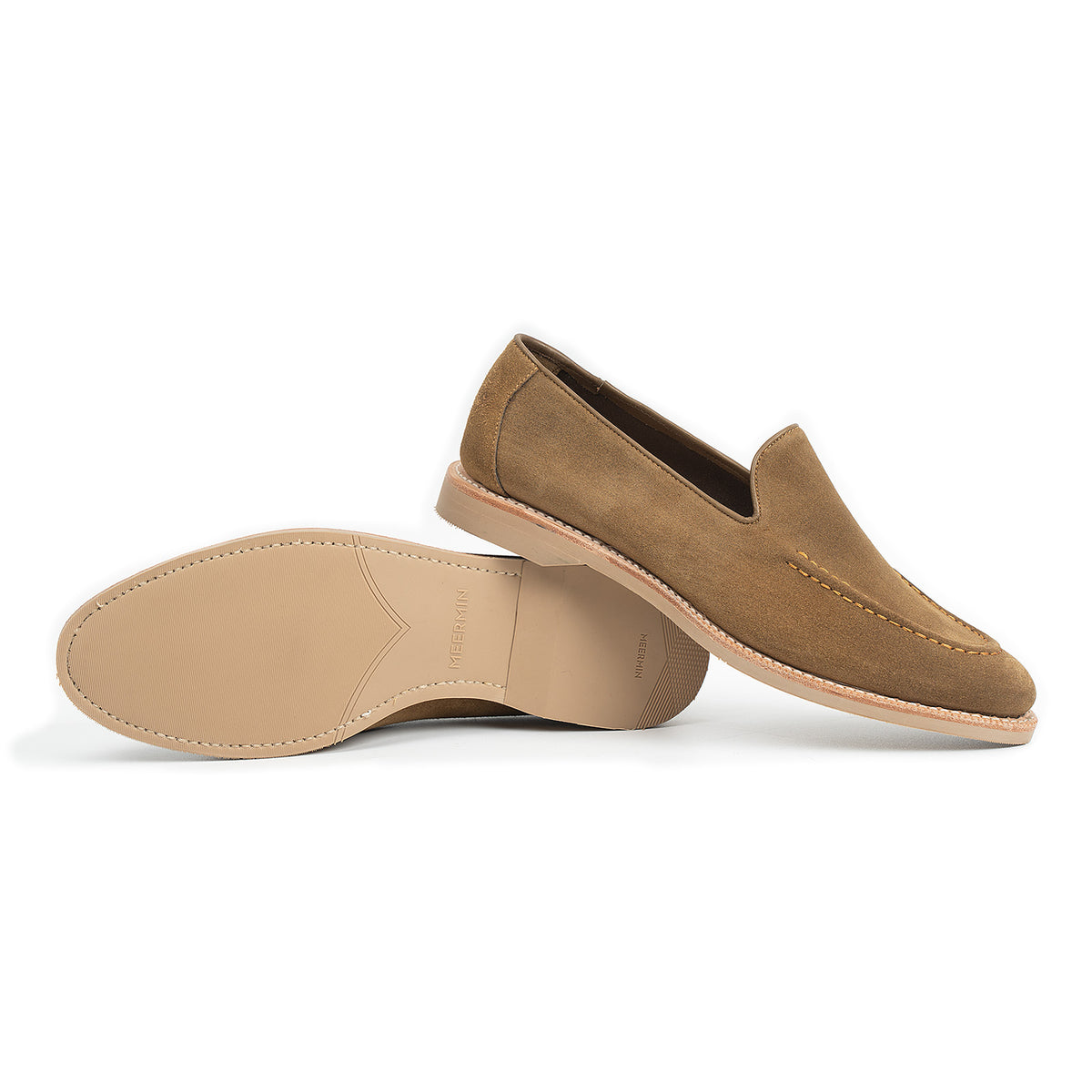 Meermin Atacama suede unlined loafers shown side by side, one upright displaying the profile, the other tipped to reveal the taupe rubber sole