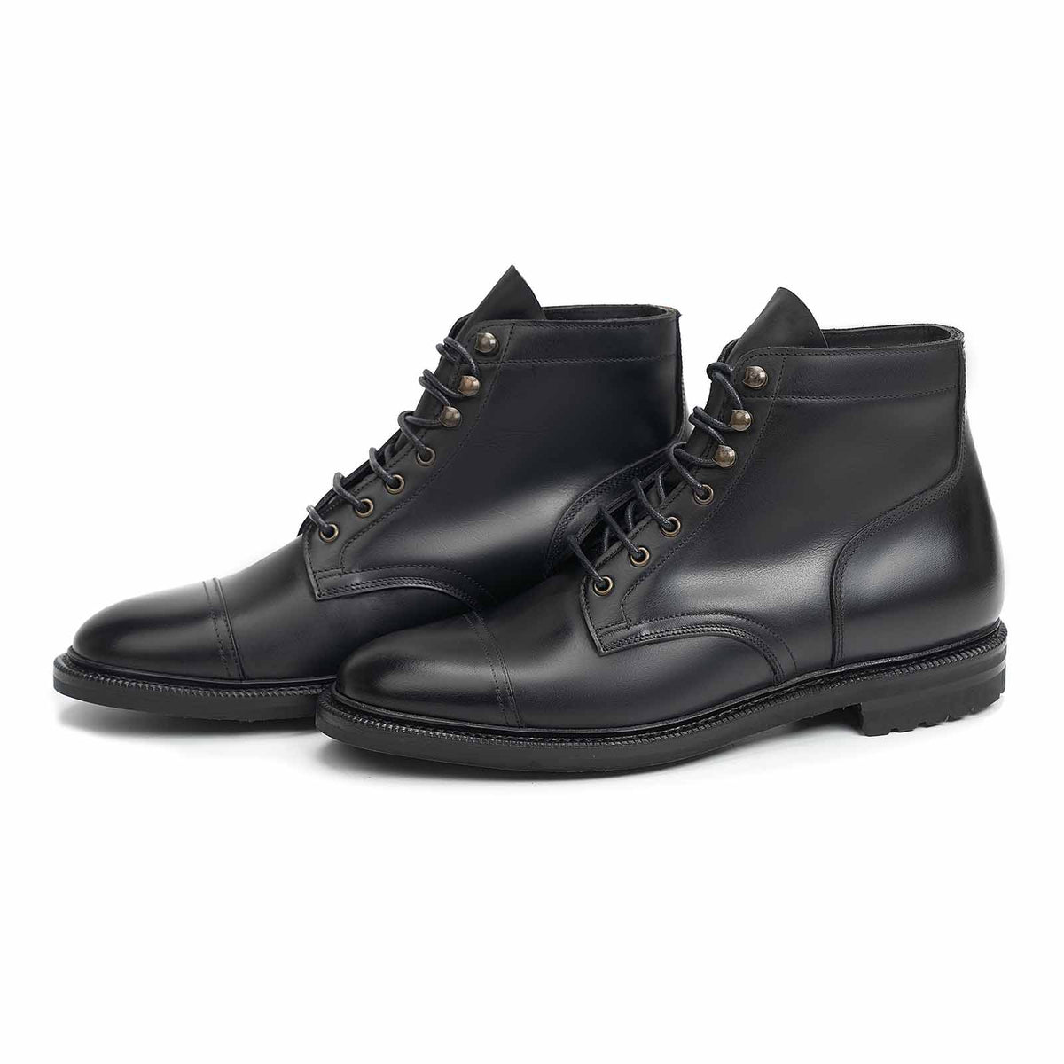 Meermin black waxy calf cap-toe boots, three-quarter front view showing both pairs, lace-up derby-style shaft on NEGON last