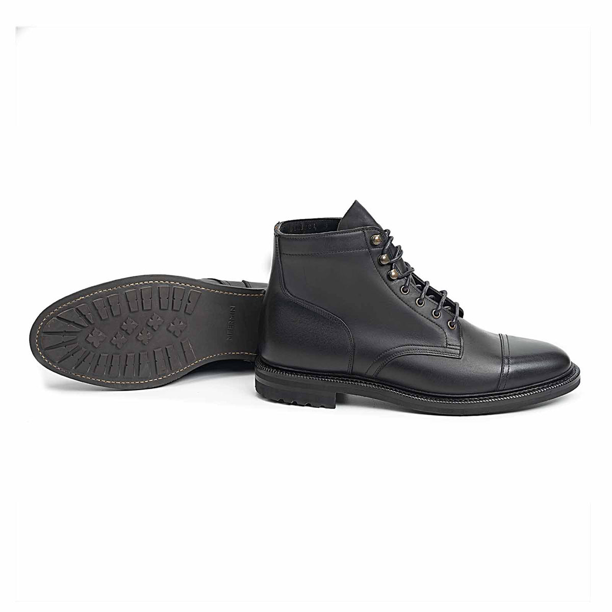 Meermin black waxy calf cap-toe boots, side profile with sole tread pattern shown from paired boot lying on its side